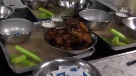 Learning the proper way to sauce chicken wings with Duckworth’s Grill